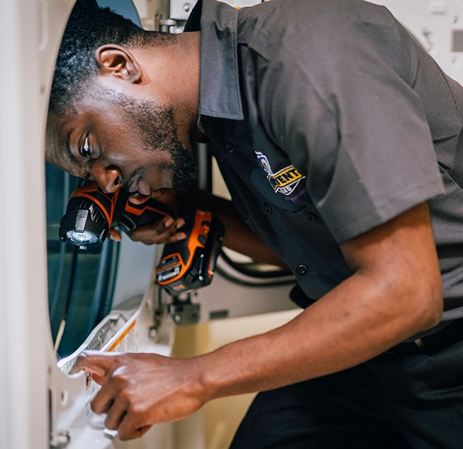 Technician inspecting lint trap.