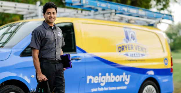 Technician standing next to Dryer Vent Wizard van.